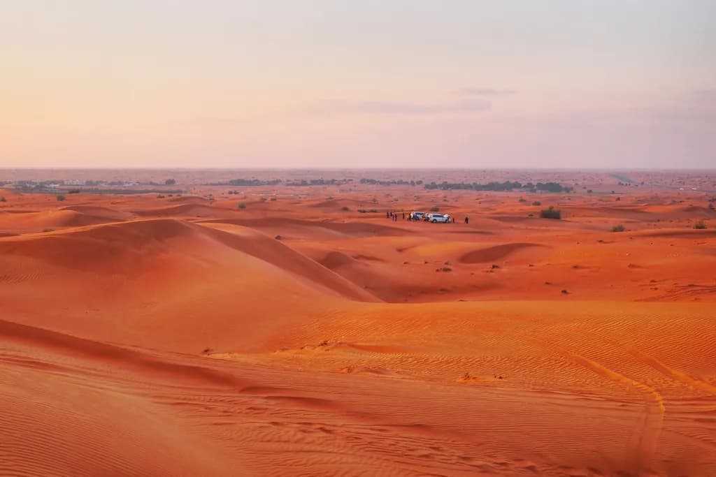 Orange desert dunes at sunset