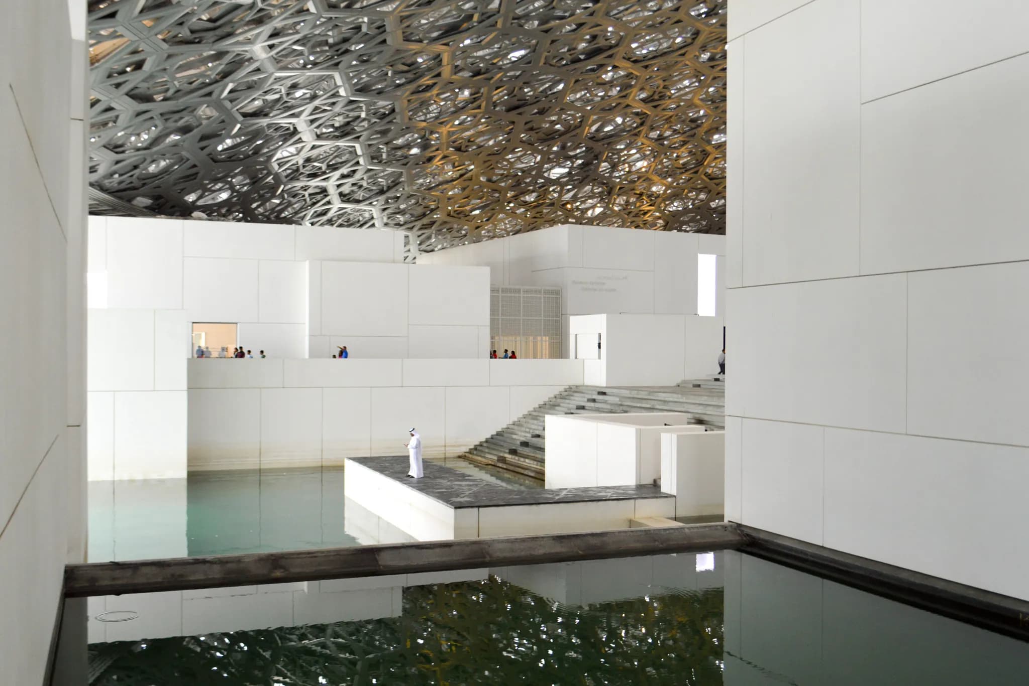 Light falling through the dome of the Louvre Abu Dhabi onto the water